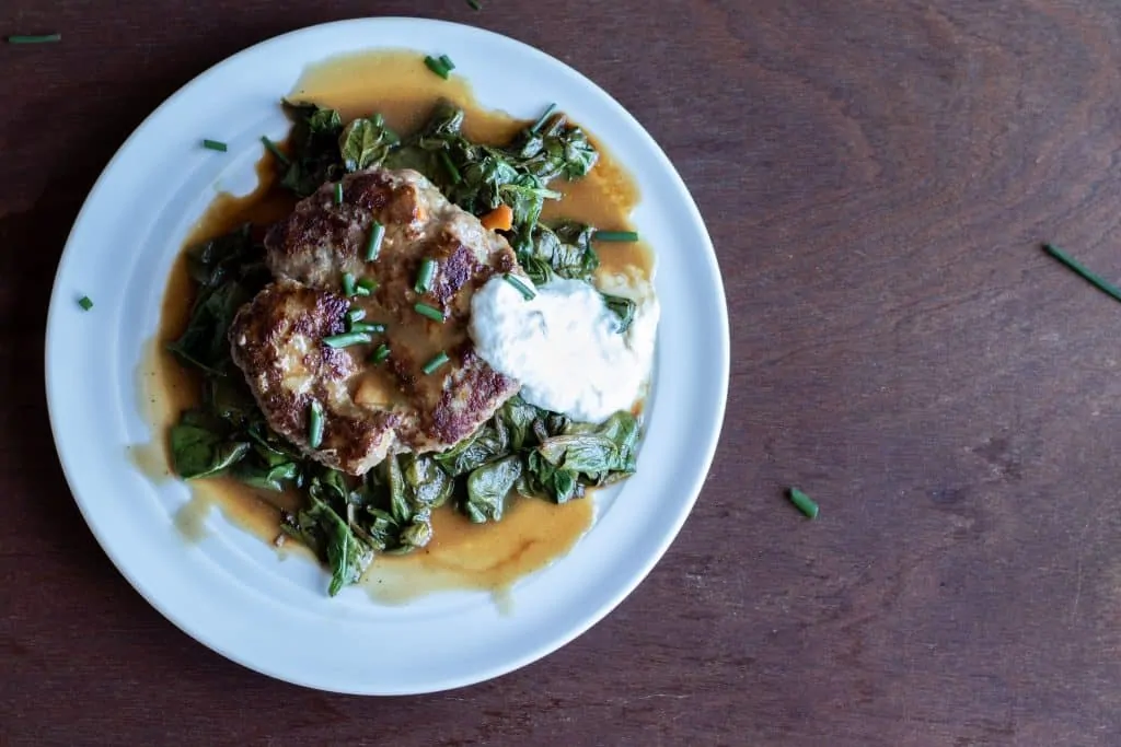 Salisbury Mushroom Steak with Gravy and Creamy Horseradish and Sautéed Spinach Step 13 Plate the Salisbury Steak