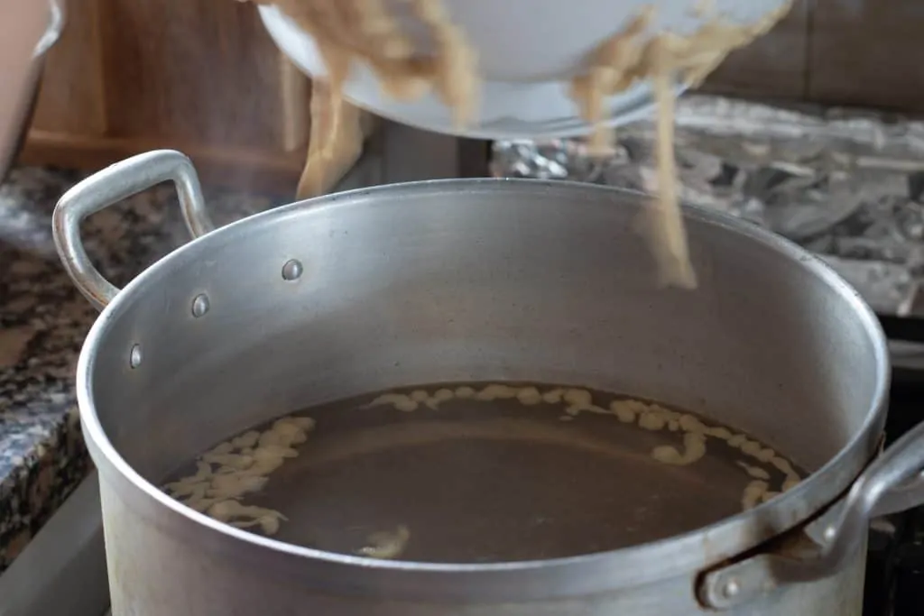 Butter Sauteed Herb Spaetzle with Crispy Smoked Ham Step 4 drop into boiling water