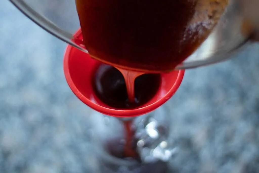 Pomegranate Orange Barbecue Sauce Step 8 pour the sauce through a funnel